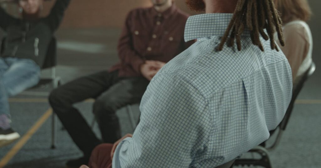 A diverse group of adults engaging in a support therapy session in an indoor setting.